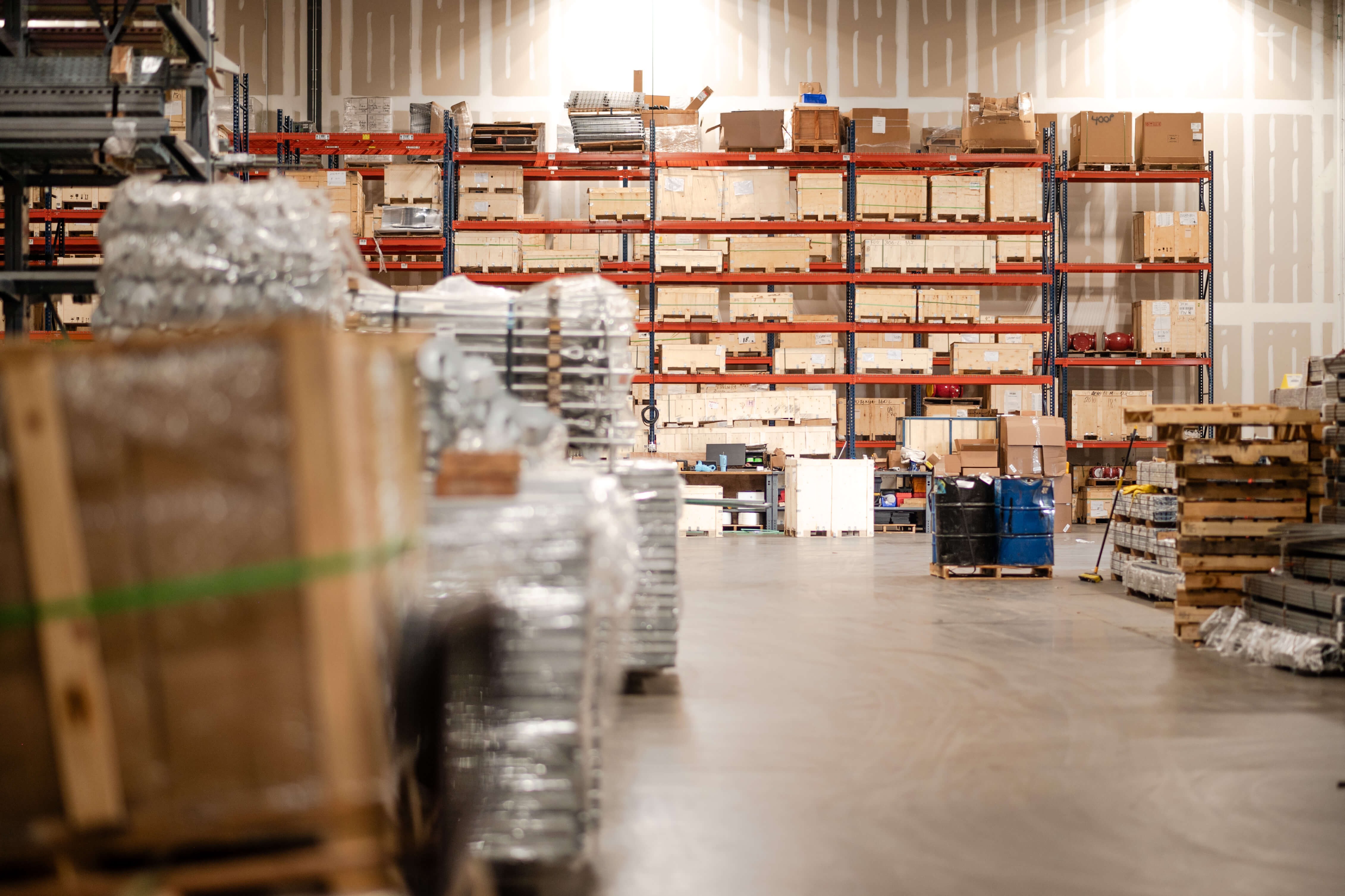 United Water Products warehouse with organized industrial shelving, stocked pallets, and crated valve and hydrant inventory – showcasing reliable waterworks product distribution and supply chain efficiency.